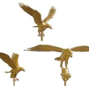 Three golden eagle statues in flight positions