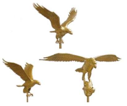 Three golden eagle statues in flight positions