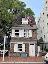 Historic brick house with American flag.