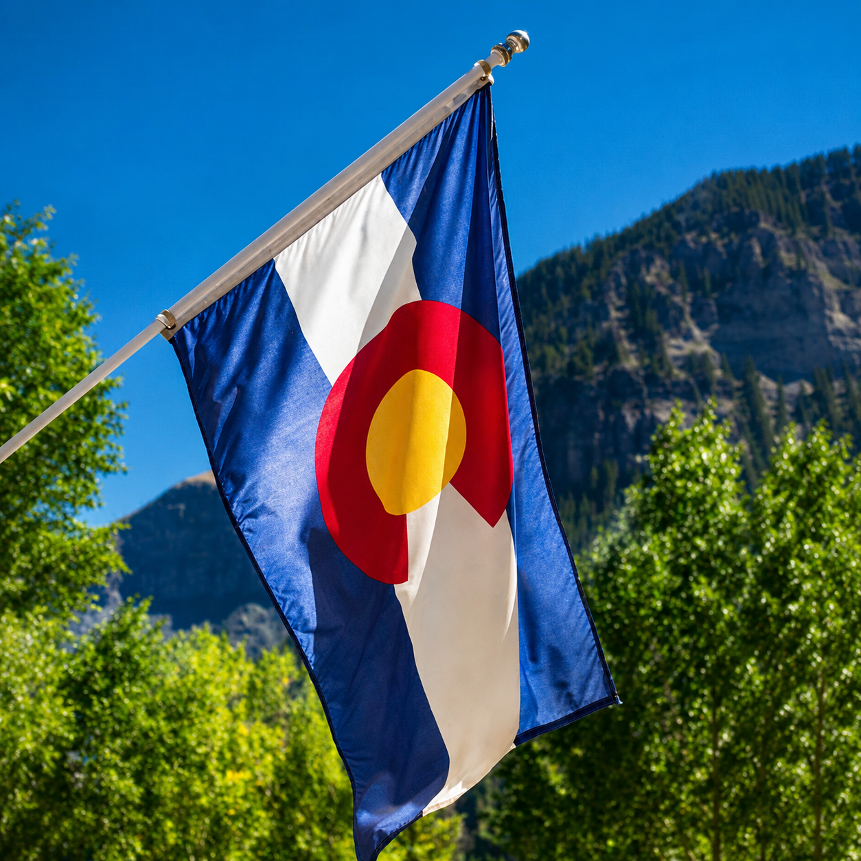 Colorado state flag waving before mountain landscape