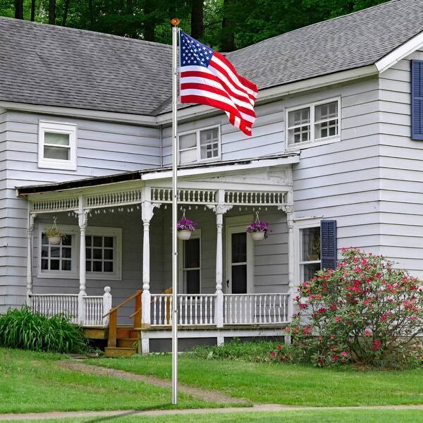 flgres American flag flying outside a white porch-front home